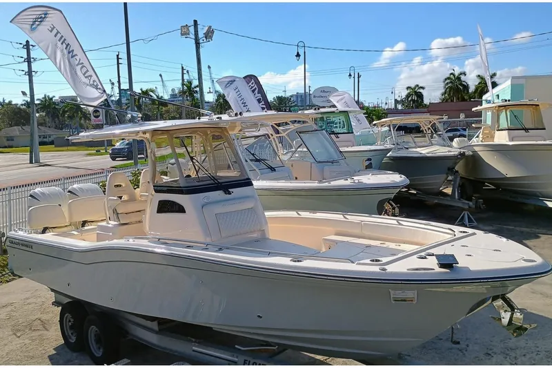 Slide: The Image of 2025 Grady-White 281 Coastal Explorer boat displayed on a trailer at a dealership. - 5