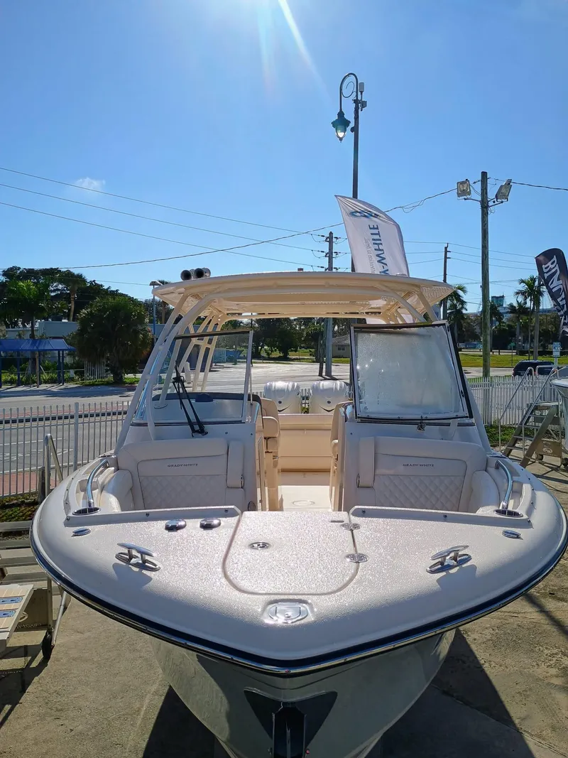 Slide: The Image of 2025 Grady-White Freedom 285 boat, docked under clear blue sky, showcasing sleek design. - 3