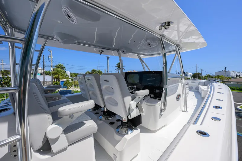 Slide: The Image of 2025 Contender 44ST boat cockpit with modern seating and controls under a sleek canopy. - 15