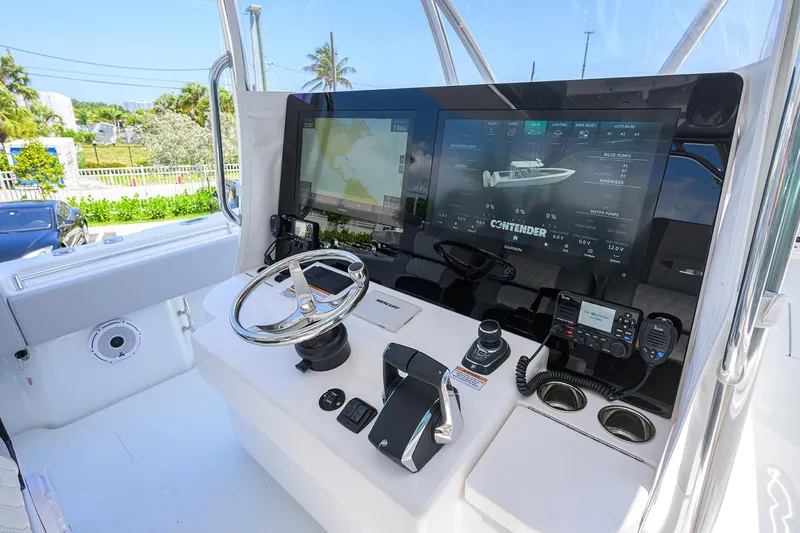 Slide: The Image of 2025 Contender 44ST boat dashboard with advanced navigation and control systems. - 16