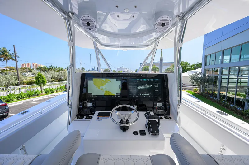 Slide: The Image of Cockpit of 2025 Contender 44ST boat with advanced navigation system and sleek design. - 18