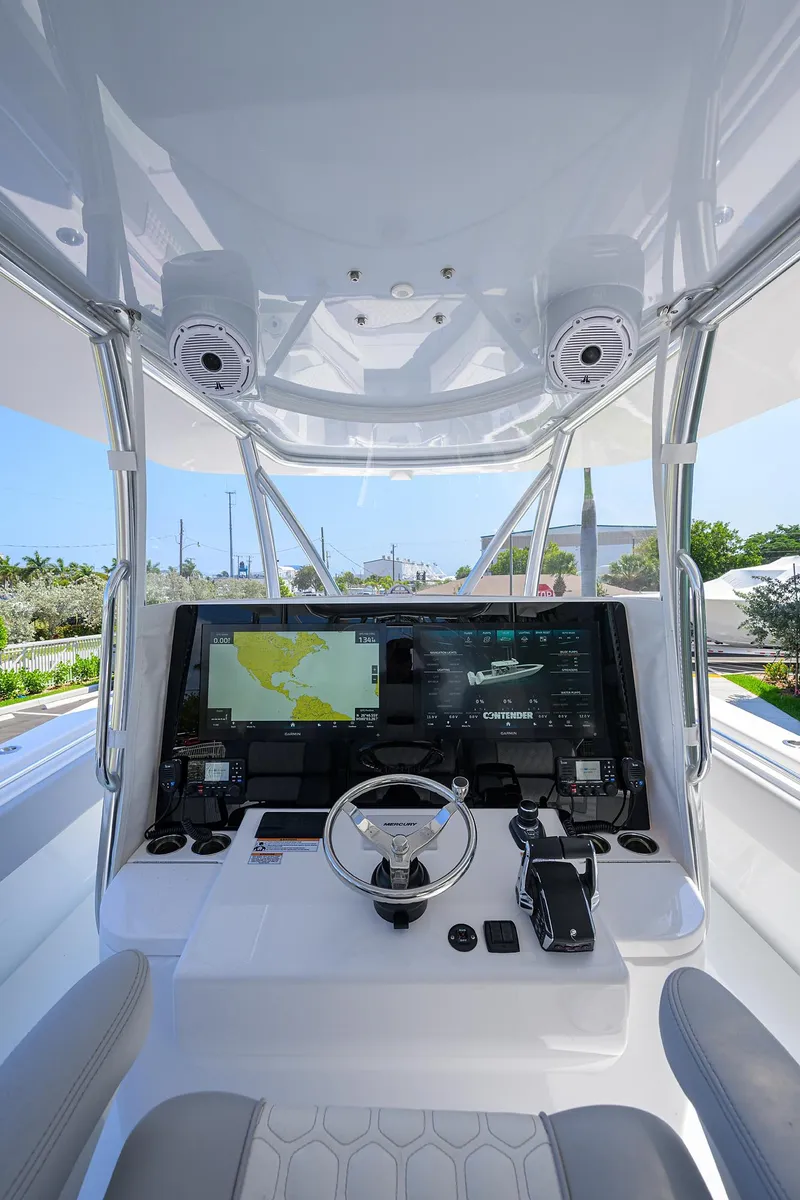 Slide: The Image of 2025 Contender 44ST boat cockpit with advanced navigation system and sleek design. - 20