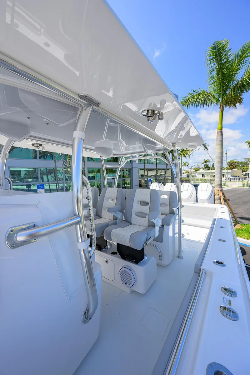 Slide: The Image of 2025 Contender 44ST boat interior with sleek seating and modern design under a clear blue sky. - 24