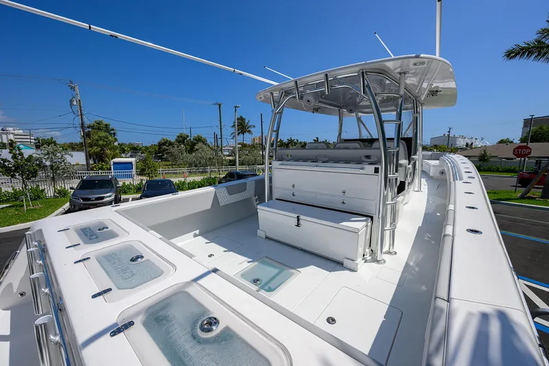 Slide: The Image of 2025 Contender 44ST boat with spacious deck and modern amenities, parked outdoors. - 26