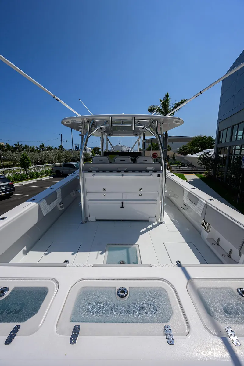 Slide: The Image of 2025 Contender 44ST boat, spacious deck, clear sky, modern design. - 28