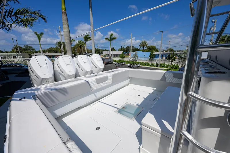 Slide: The Image of 2025 Contender 44ST boat with quad engines, spacious deck, and modern design under clear blue skies. - 30