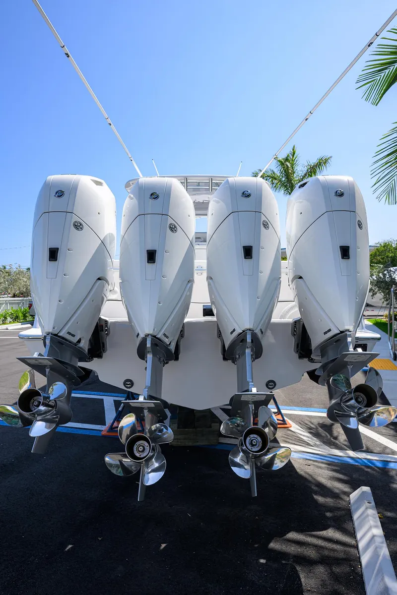 Slide: The Image of 2025 Contender 44ST boat with four powerful outboard engines, rear view. - 35