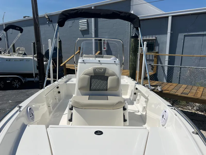 Slide: The Image of 2025 Key West 1720 Center Console boat with seating and canopy in a marina setting. - 11