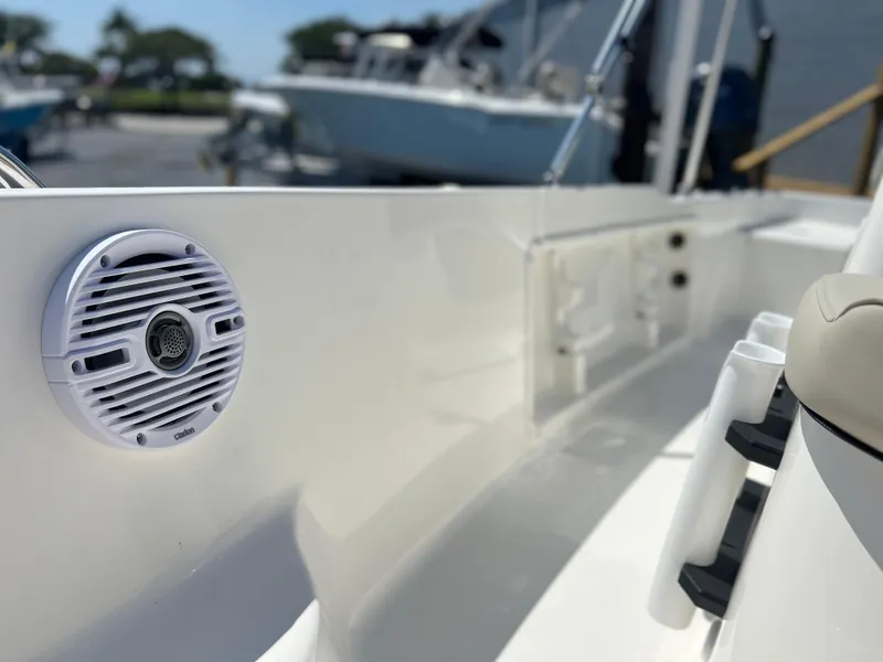 Slide: The Image of 2025 Key West 1720 Center Console boat interior with speaker and rod holders. - 14