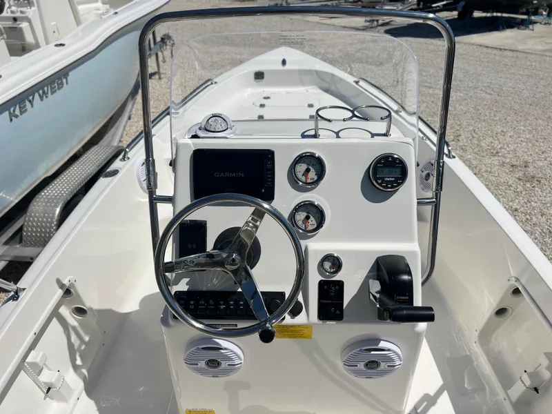 Slide: The Image of 2025 Key West 1720 Center Console boat interior with steering wheel and gauges. - 19