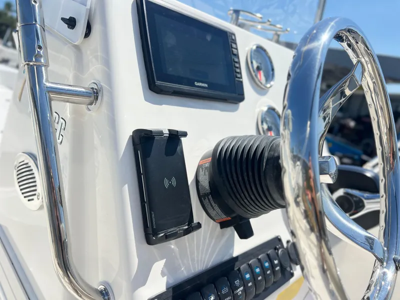 Slide: The Image of 2025 Key West 1720 Center Console boat dashboard with steering wheel and navigation display. - 22