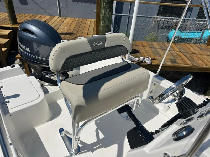 Slide: The Image of 2025 Key West 1720 Center Console boat with Yamaha engine, featuring a sleek helm seat. - 26