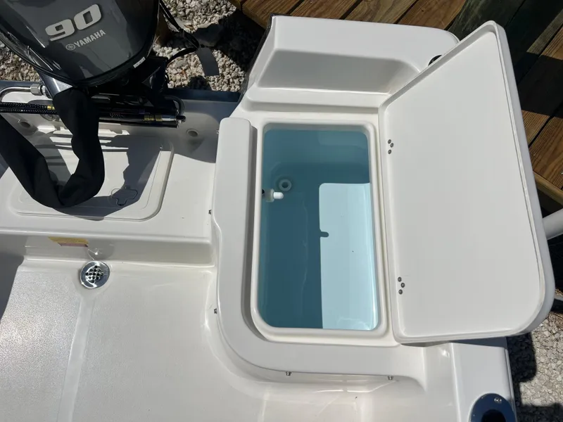 Slide: The Image of 2025 Key West 1720 Center Console boat with open storage compartment and Yamaha engine. - 29