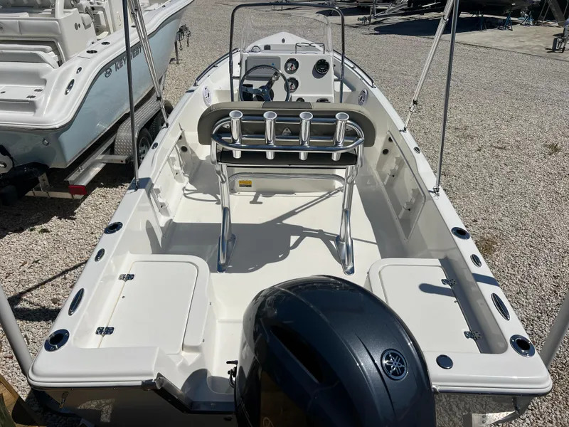 Slide: The Image of 2025 Key West 1720 Center Console boat with Yamaha engine, docked on gravel. - 32