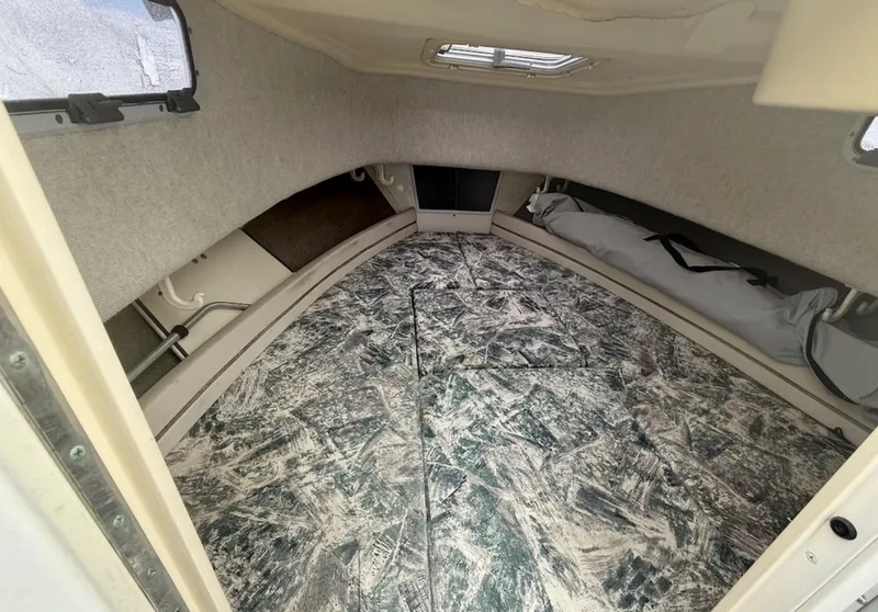 Slide: The Image of 2000 Grady-White Adventure 208 cabin interior with patterned flooring and storage space. - 12