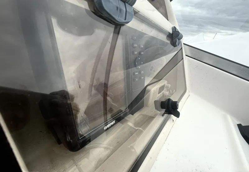 Slide: The Image of Console of 2000 Grady-White Adventure 208 boat with Garmin navigation system. - 13