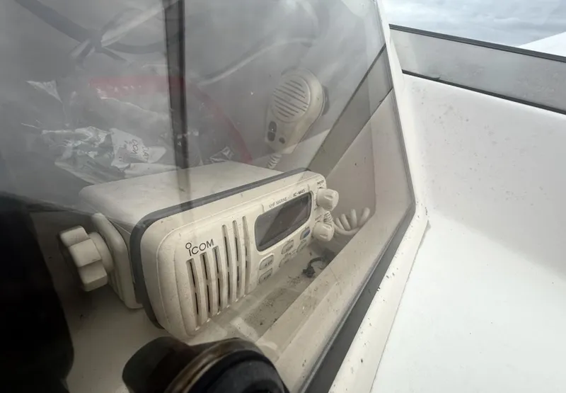 Slide: The Image of Icom marine radio inside a 2000 Grady-White Adventure 208 boat cockpit. - 14