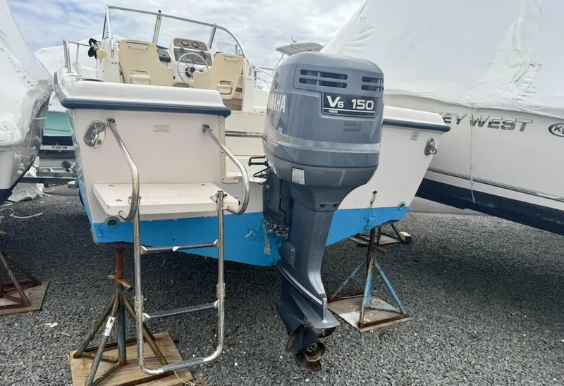 Slide: The Image of 2000 Grady-White Adventure 208 boat with Yamaha V6 150 outboard motor on stands. - 18