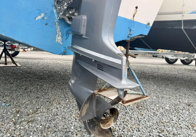 Slide: The Image of Outboard motor of 2000 Grady-White Adventure 208 on gravel surface. - 22