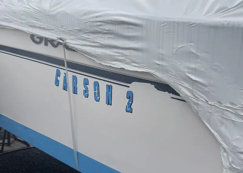 Slide: The Image of 2000 Grady-White Adventure 208 boat partially covered, displaying "CARSON 2" on the side. - 3