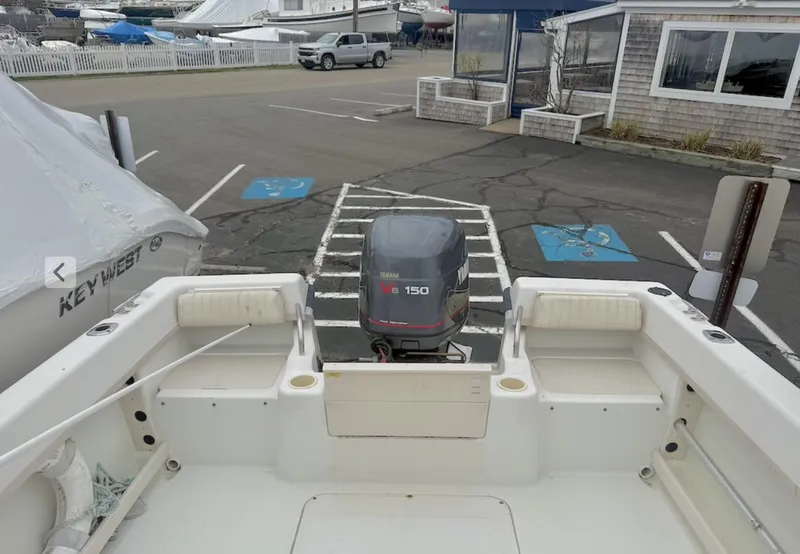 Slide: The Image of 2000 Grady-White Adventure 208 boat with outboard motor in a parking lot. - 5