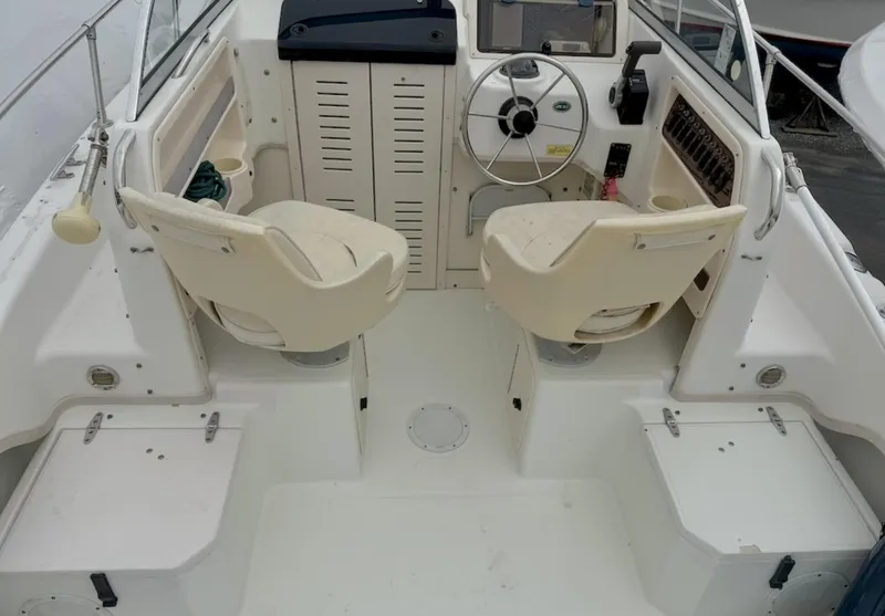 Slide: The Image of 2000 Grady-White Adventure 208 boat interior with dual seats and steering wheel. - 7