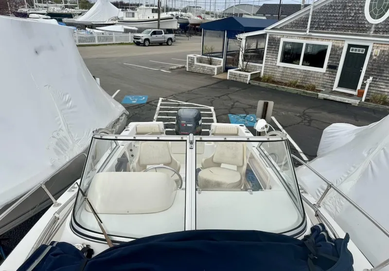 Slide: The Image of 2000 Grady-White Adventure 208 boat docked, covered, with marina background. - 8