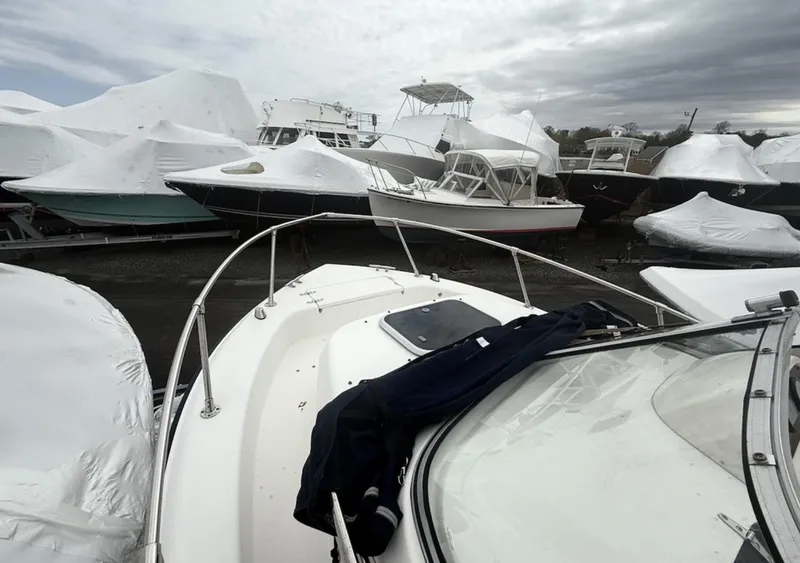Slide: The Image of Boats in storage, including a 2000 Grady-White Adventure 208, covered for winter. - 9