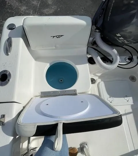 Slide: The Image of 2024 Tidewater 180 CC Adventure boat interior with open storage compartment and seating. - 10