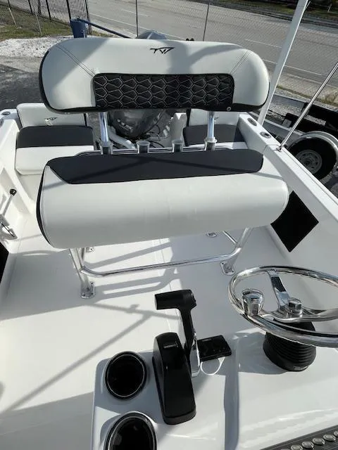 Slide: The Image of 2024 Tidewater 180 CC Adventure boat interior with steering wheel and seating. - 5