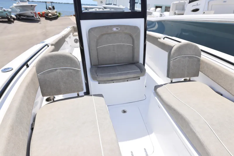 Slide: The Image of 2026 Sea Hunt Ultra 255 SE boat interior with cushioned seating and modern design. - 13