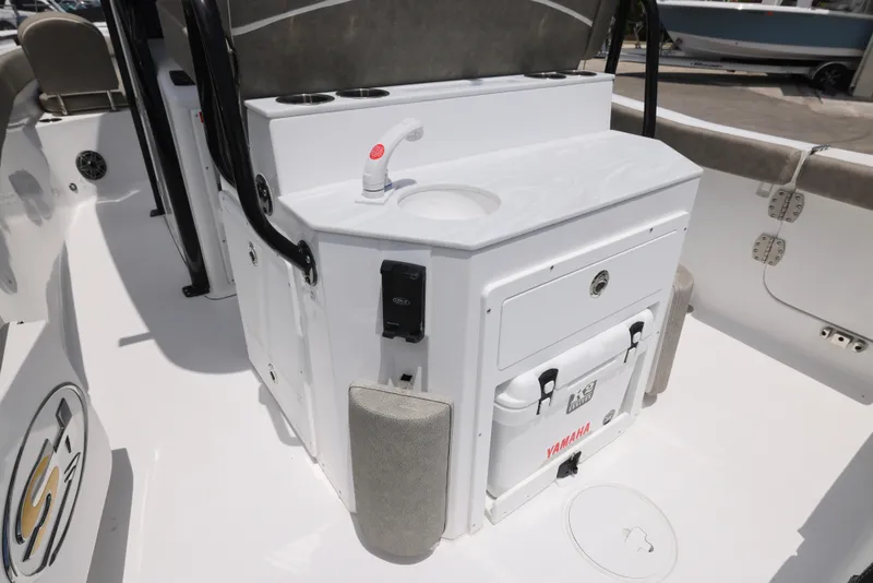 Slide: The Image of 2026 Sea Hunt Ultra 255 SE boat interior with cushioned seating and storage. - 18