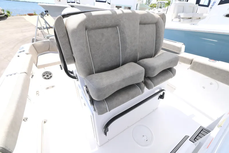 Slide: The Image of 2026 Sea Hunt Ultra 255 SE boat interior with cushioned seating and speakers. - 21