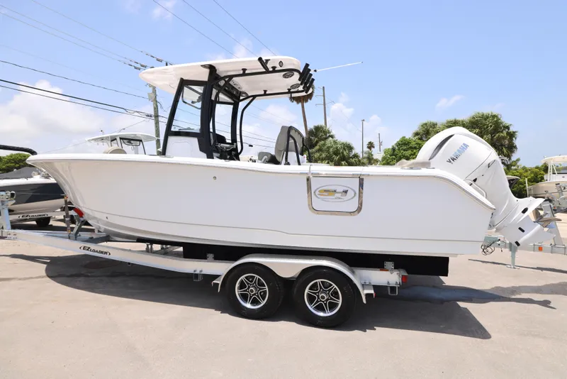 Slide: The Image of 2026 Sea Hunt Ultra 255 SE boat cruising on open water, aerial view. - 27