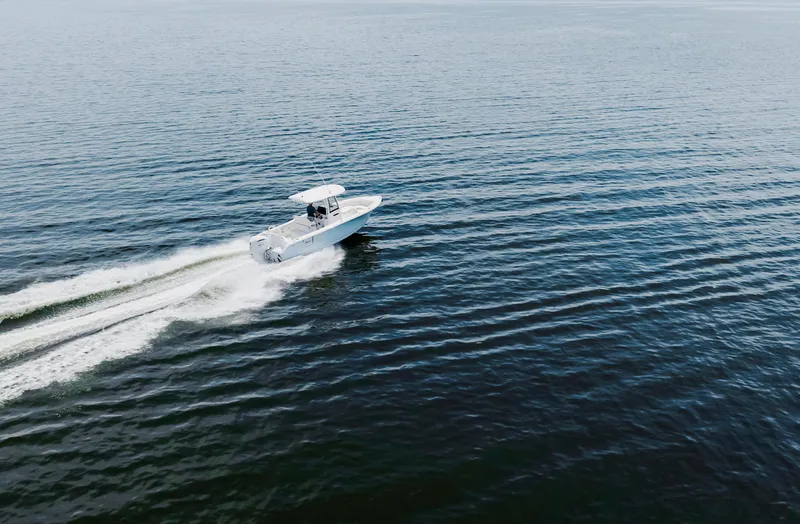 Slide: The Image of 2026 Sea Hunt Ultra 255 SE boat with 350 V8 engine on a calm lake. - 36