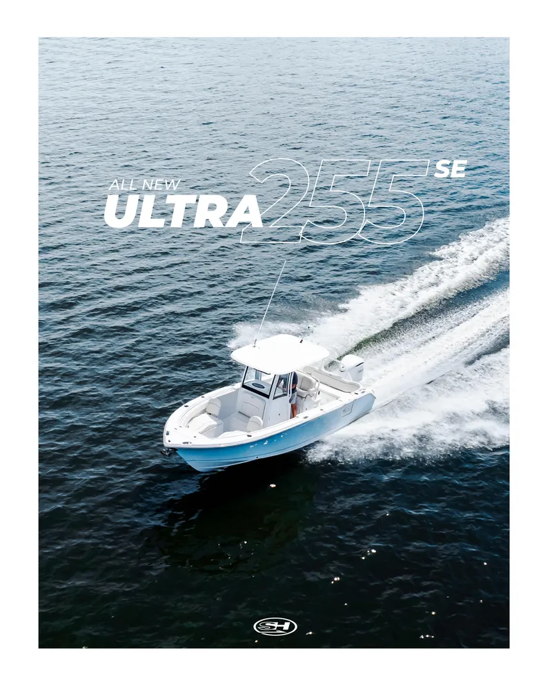 Slide: The Image of 2026 Sea Hunt Ultra 255 SE boat cruising on a serene lake with lush shoreline. - 39