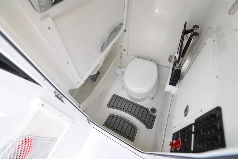 Slide: The Image of 2026 Sea Hunt Ultra 255 SE boat seating area with gray cushions and Yamaha engine. - 8