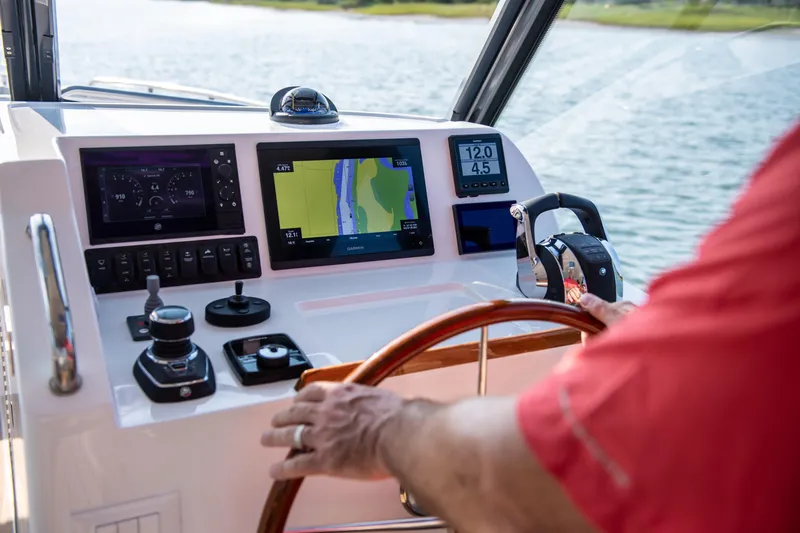 Slide: The Image of 2025 MJM 3 boat dashboard with navigation screens and controls on a sunny day. - 21