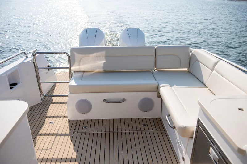 Slide: The Image of 2025 MJM 3 boat deck with white seating, overlooking calm water. - 26
