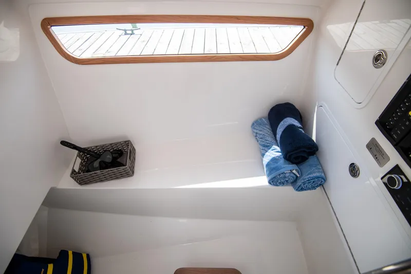 Slide: The Image of Interior of 2025 MJM 3 boat with towels and basket, featuring sleek design. - 27