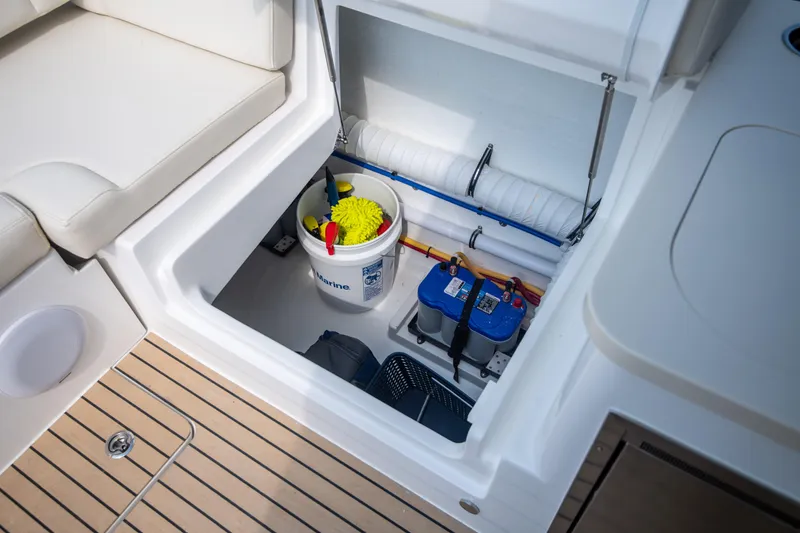 Slide: The Image of Storage compartment on 2025 MJM 3 boat with cleaning supplies and equipment. - 28
