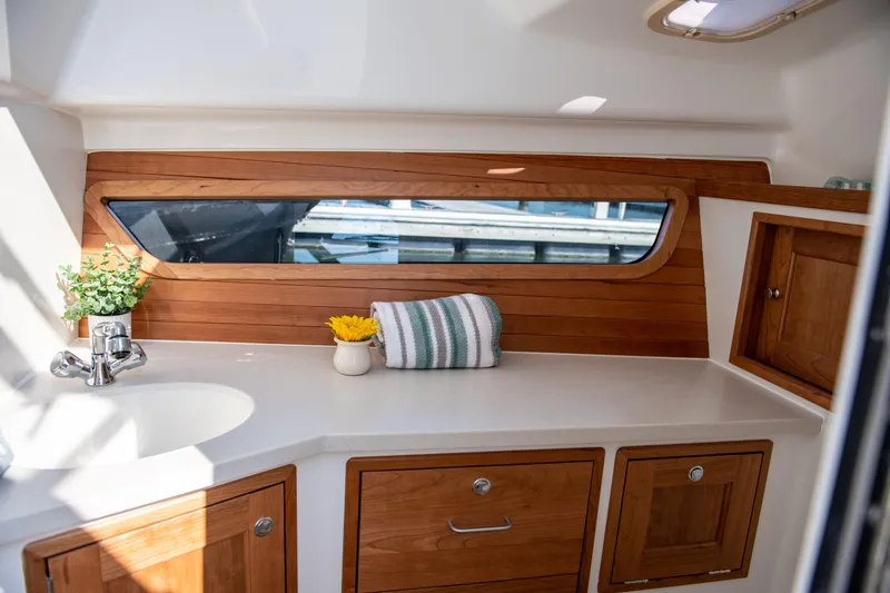 Slide: The Image of Interior of 2025 MJM 3 boat with wooden cabinetry and modern sink. - 30