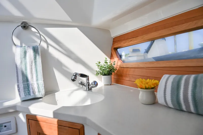 Slide: The Image of Modern MJM 3 yacht bathroom with sleek sink, wooden accents, and natural light, 2025 model. - 31
