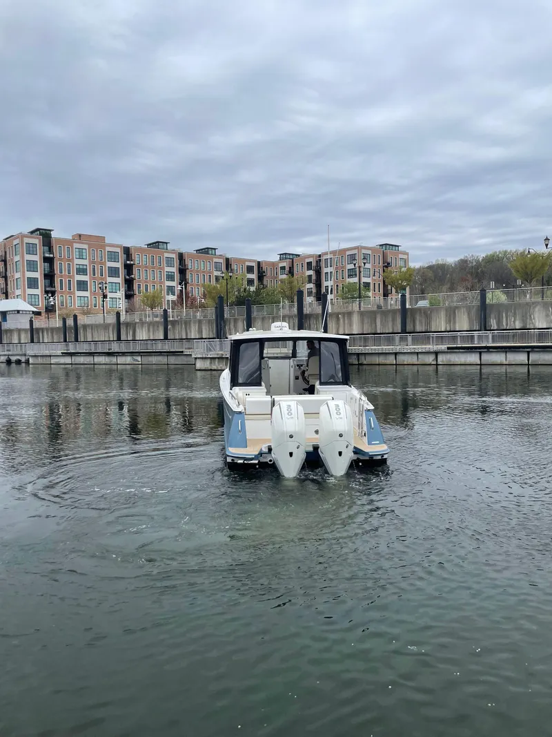 Slide: The Image of 2025 MJM 3 boat in marina with modern buildings in background. - 5