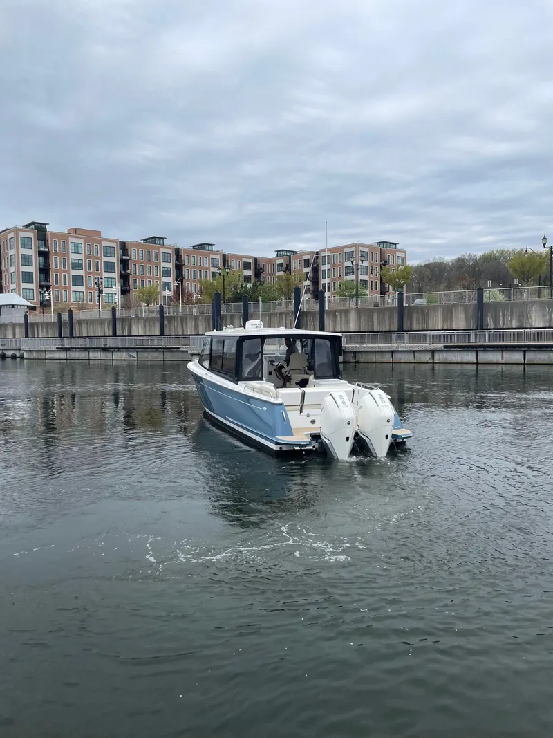 Slide: The Image of 2025 MJM 3 boat in a marina with modern buildings in the background. - 6