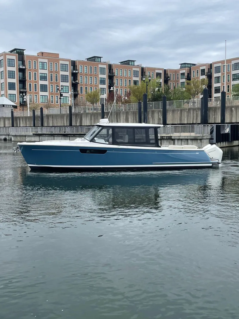 Slide: The Image of 2025 MJM 3 boat docked in urban marina with modern buildings. - 8