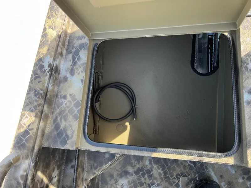 Slide: The Image of Open storage compartment in 2025 Excel Eclipse boat with camouflage pattern. - 11