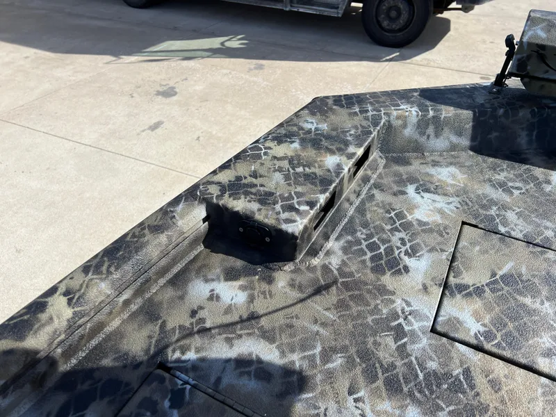 Slide: The Image of Camouflage-patterned surface of a 2025 Excel Eclipse vehicle, showcasing intricate design details. - 13