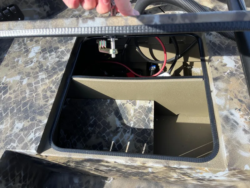 Slide: The Image of Open compartment of 2025 Excel Eclipse boat showing internal wiring and storage space. - 19