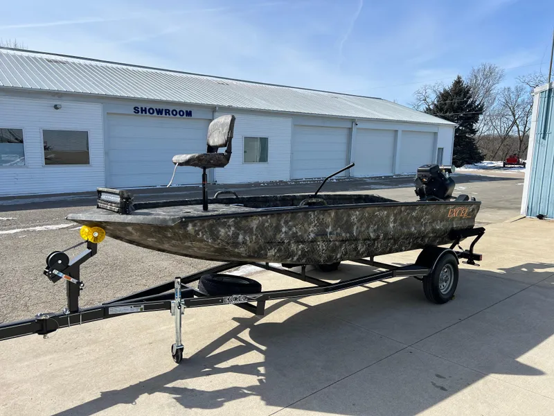 Slide: The Image of 2025 Excel Eclipse boat on trailer outside showroom, featuring camouflage design and elevated seat. - 3